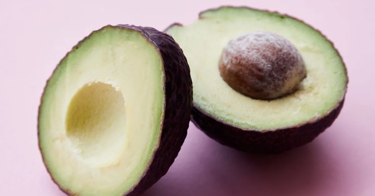 A halved avocado with the stone