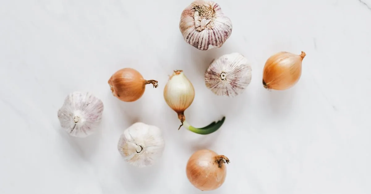 Onions and garlic on a light surface