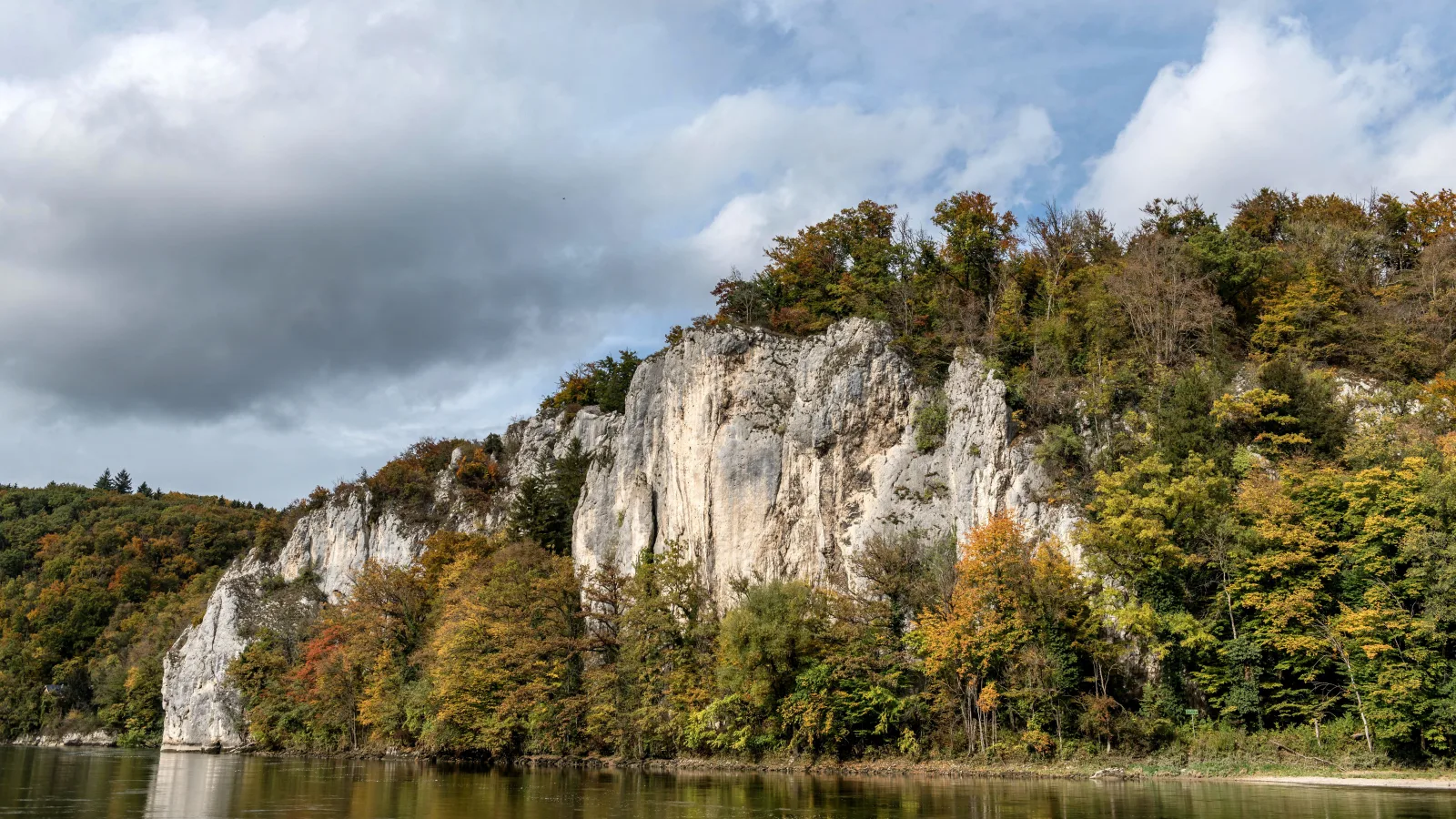 Limestone crags above a river surrounded by autumn woodland