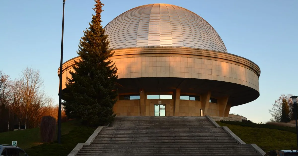 The Silesian Planetarium in Chorzow at sunset - its distinctive dome standing inside Park Slaski